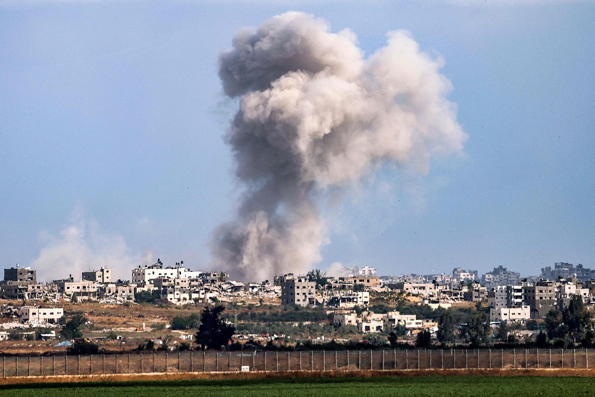 A smoke plume from an explosion billows in the Gaza Strip as seen from a position along Israel’s southern border with the Palestinian territory on 13 May, 2024 amid the ongoing conflict between Israel and the militant group Hamas